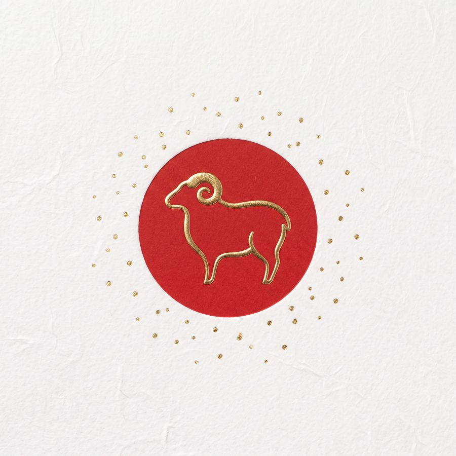 Gold foil sheep silhouette in red circle on white paper, minimal Japanese New Year design