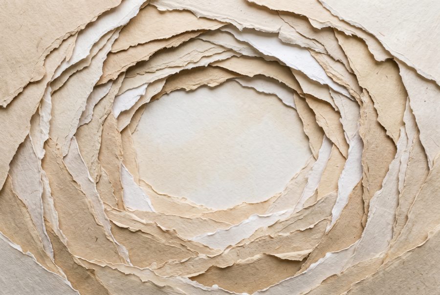 Layered torn paper background in beige and sand tones with soft shadows