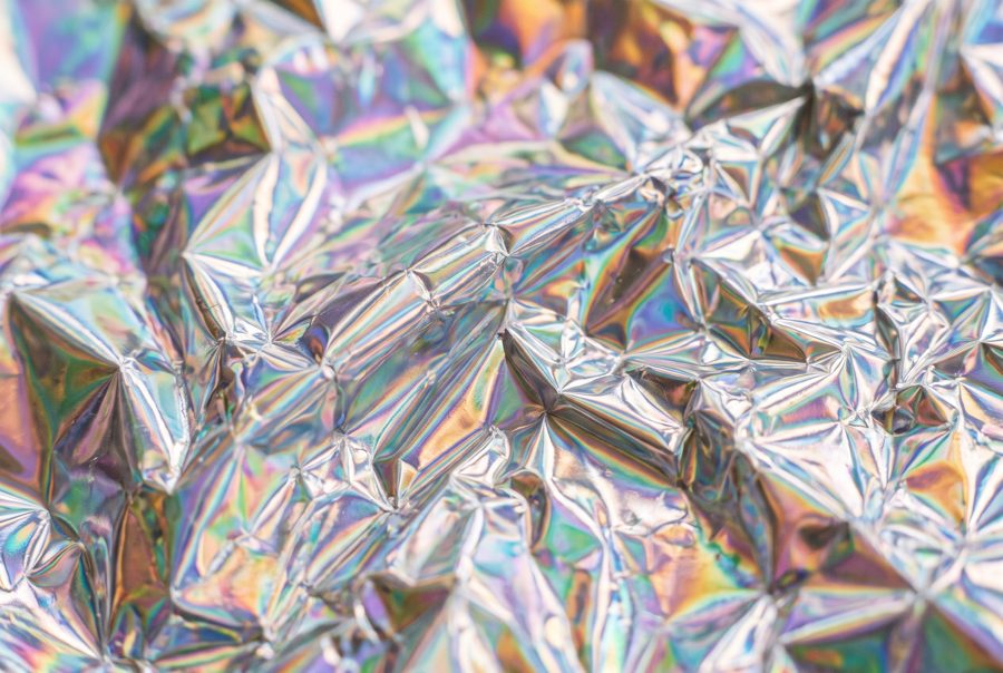 Crumpled holographic iridescent foil texture, pastel rainbow abstract background
