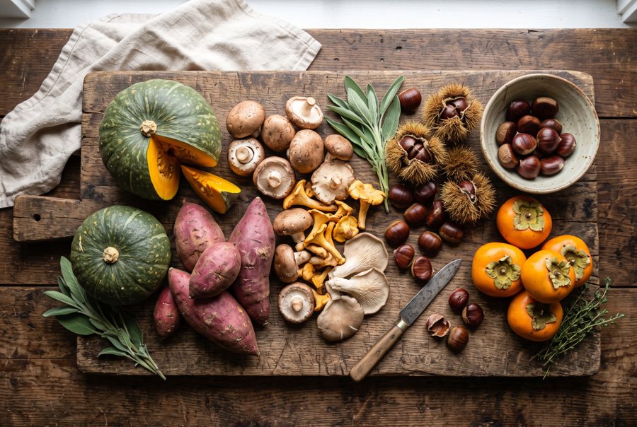 Autumn harvest vegetables with squash, sweet potatoes, chestnuts and persimmons, top view