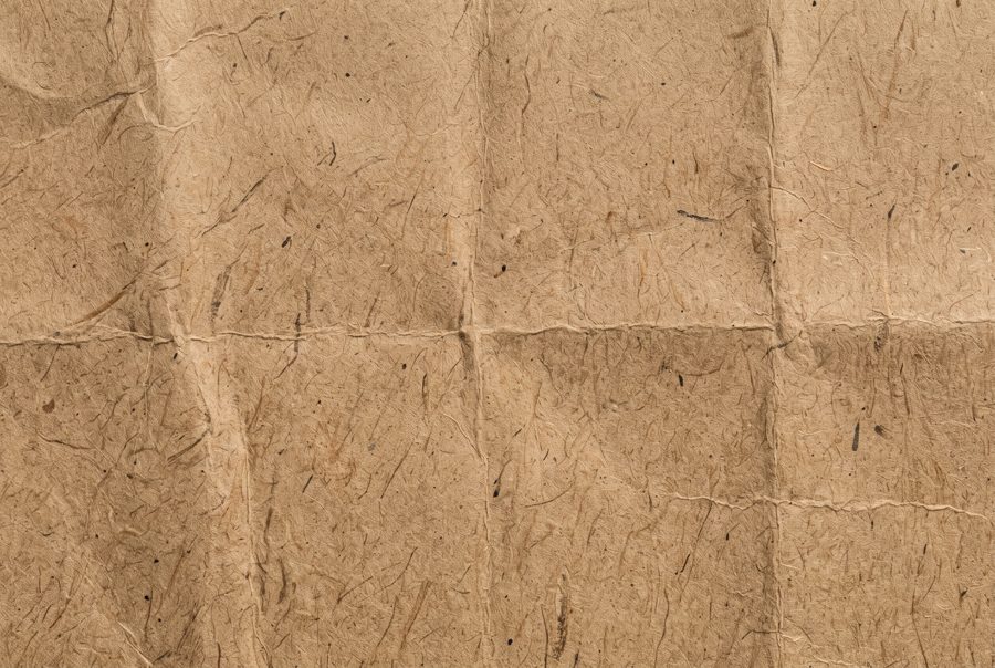 Brown kraft paper texture with fine fibers, full frame background